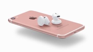Image of Apple Airpods sitting on top of Rose Gold iPhone 7