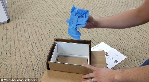 Picture of fire proof Samsung Note 7 box with fire resistant gloves.