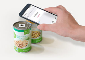 Image of hand with smart phone scanning NFC tag.