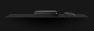 an xbox one x console and controller